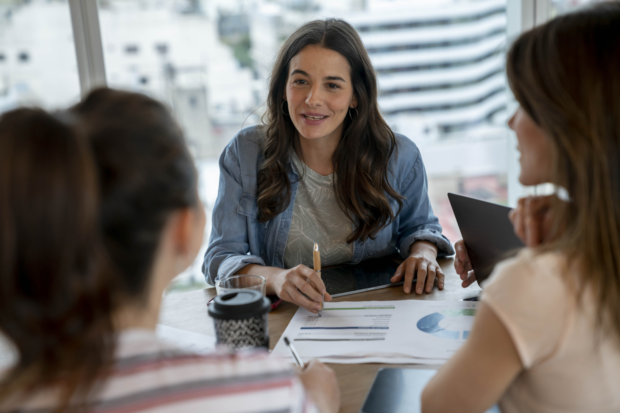 Three woman working around a table