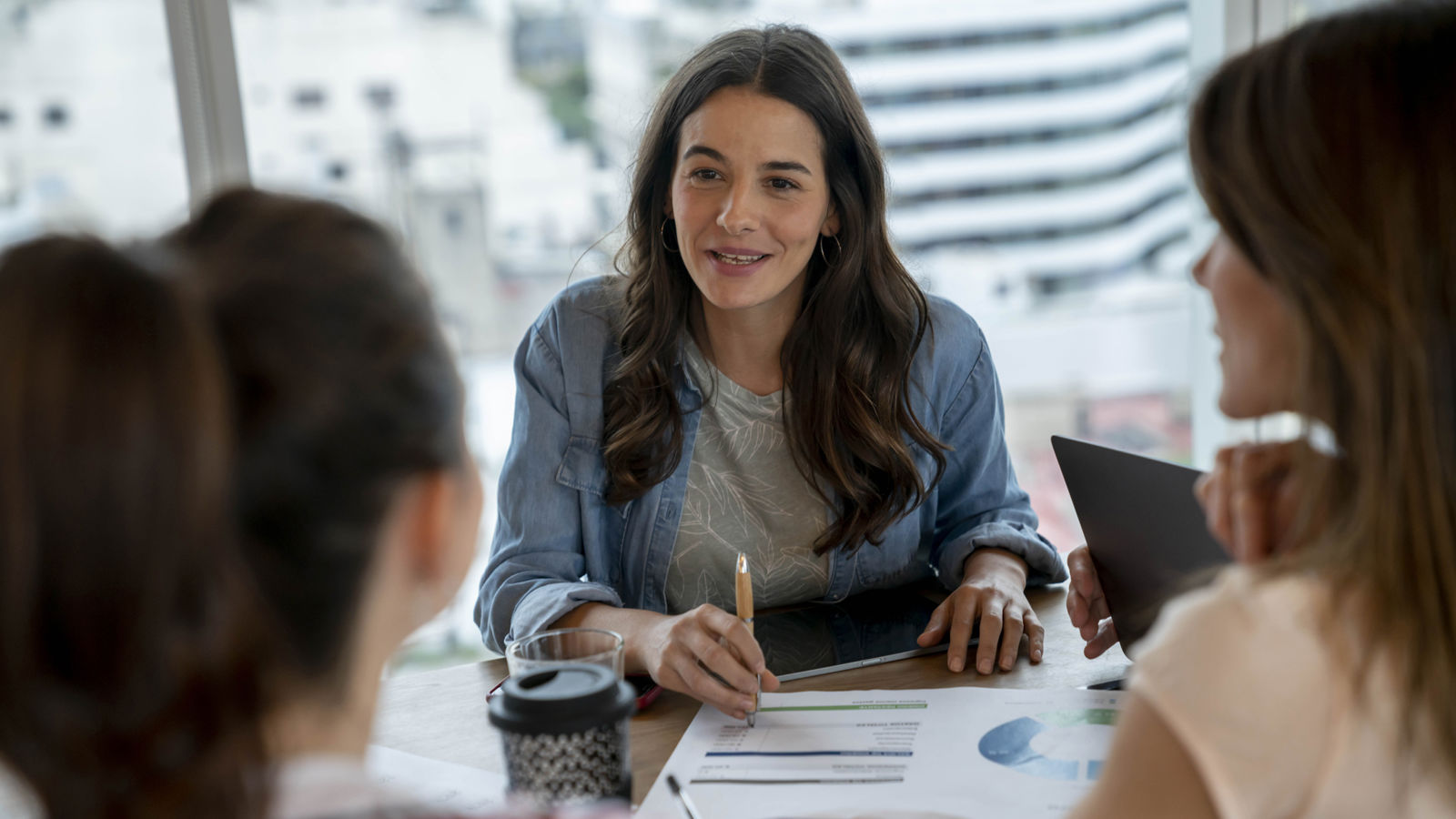 Three woman working around a table